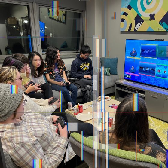 A group of students are gathered around a TV playing Mario Kart for a Digital Studies Institute event. 